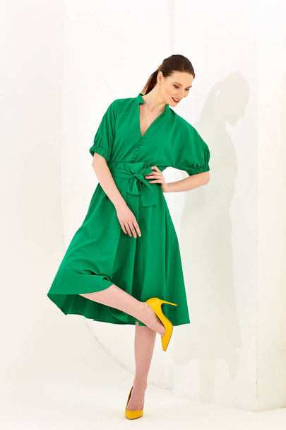 young girl standing in green dress - Valokuva, kuva