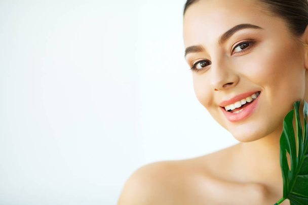 Skin Care. Beautiful Girl with Green Leaves. Beauty Treatment. Cosmetology. Beauty Spa Salon - Photo, Image