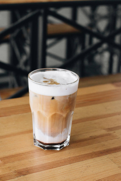 glass of delicious cappuccino coffee on wooden table  - Foto, immagini