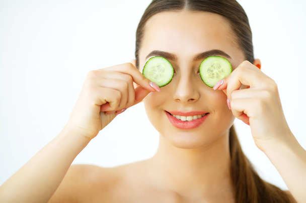 Skin Care. Portrait Beautiful Happy Woman With cucumbers to eyes at home. Beauty Treatment. Cosmetology. Beauty Spa Salon - Φωτογραφία, εικόνα