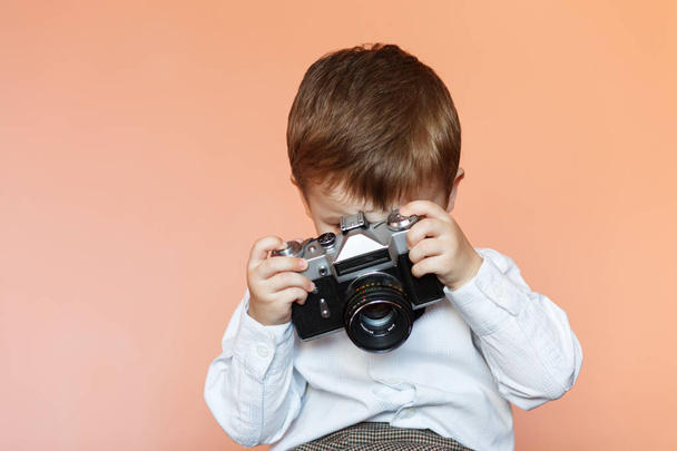 Küçük çocuk yaşlı retro kamera ile. Genç fotoğrafçı. Çocuk eski bir kamera ile - Fotoğraf, Görsel