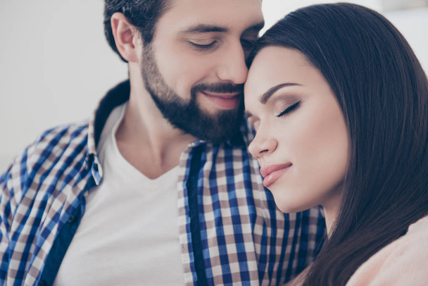 Close up cropped portrait of romantic attractive cute couple missed each other long time, bonding with close eyes, Idyllic harmony affection true feelings concept - Zdjęcie, obraz