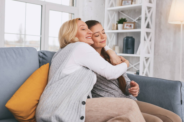 Pleased blonde embracing her daughter - Photo, Image