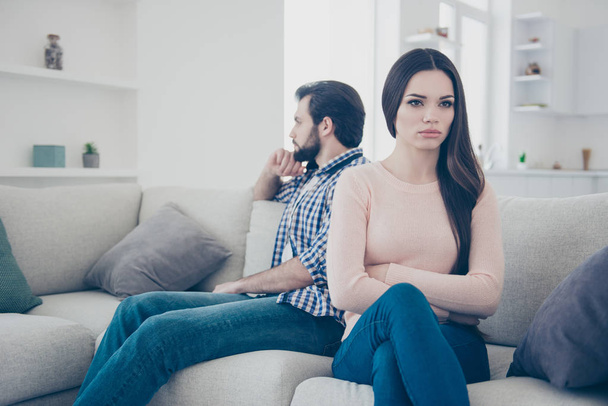 Portrait of sad couple having conflict upset girl sitting with crossed folded hands ignore her boyfriend after scandal they do not speak with each other having distrust disrespect - Foto, immagini