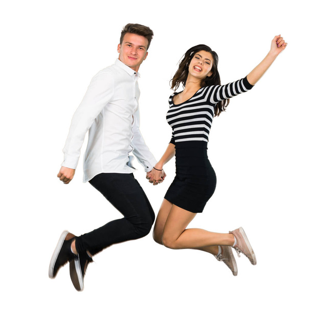 Jeune couple adolescent sautant sur fond blanc isolé
 - Photo, image