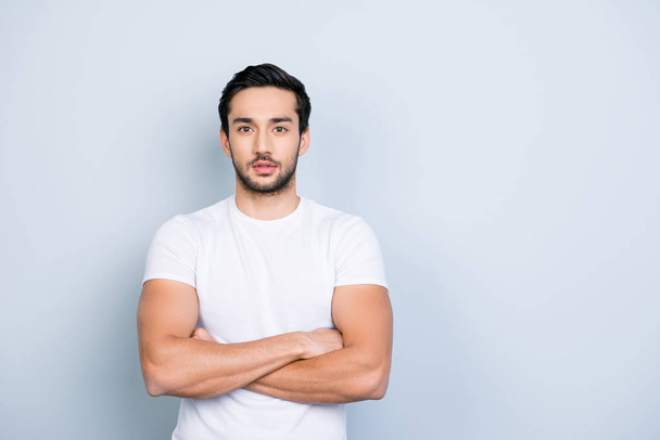 Portrait with copyspace empty place for advertisement of cute stunning strong sporty attractive manly guy holding arms crossed looking at camera isolated on grey background - Foto, immagini