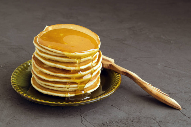 Pancakes with honey on a gray backgroun - Photo, Image