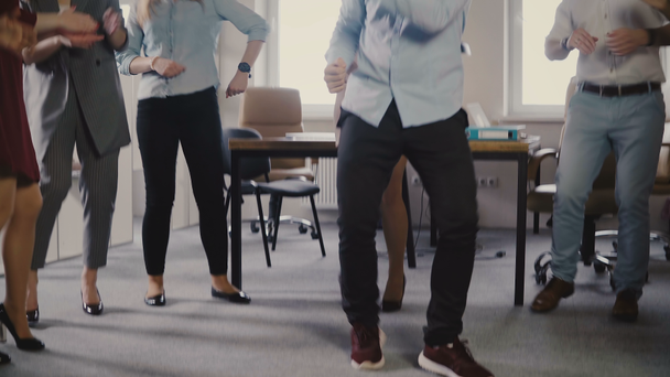 Young European businessman dancing together with colleagues at fun casual office party, celebrating career promotion 4K. - Imágenes, Vídeo