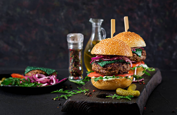Big sandwiches - burgers with beef,  tomato, basil cheese and arugula - Photo, Image