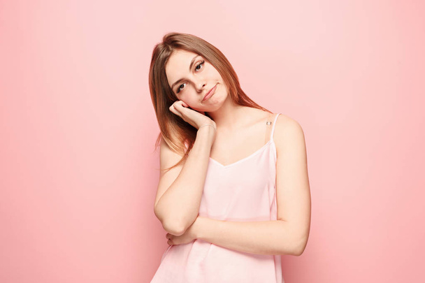 Beautiful bored woman bored isolated on pink background - Фото, изображение