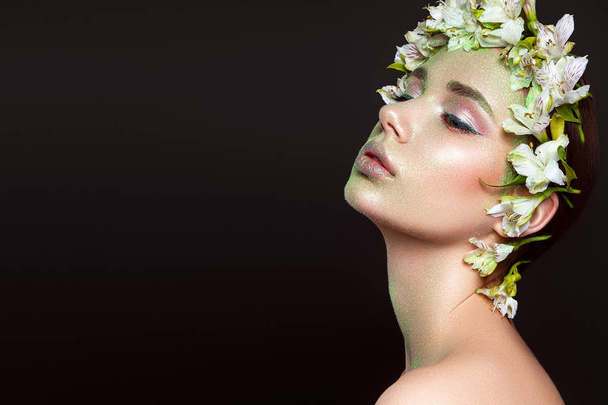 Beautiful woman portrait with flowers on head on black background - 写真・画像
