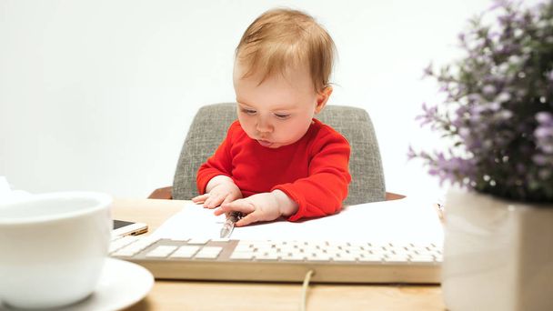Happy child baby girl toddler sitting with keyboard of computer isolated on a white background - Foto, Imagen