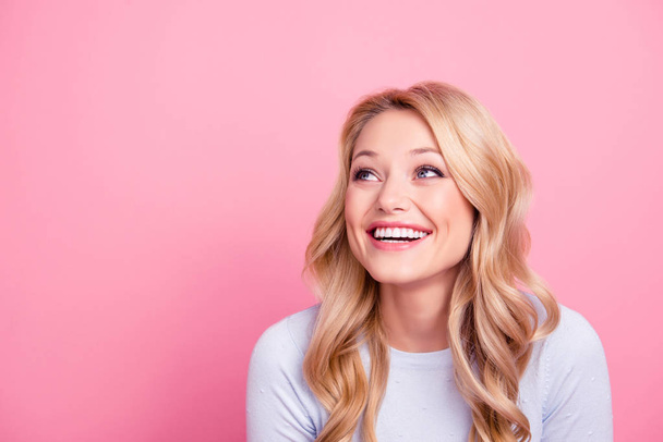 Portrait with empty place of foolish childish funny girl with modern hairdo beaming smile looking at copy space laughing isolated on pink background - Foto, Imagem