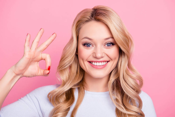 Close up portrait of sweet cute girl with modern hairstyle gesturing ok sign with fingers looking at camera isolated on pink background. Advertisement concept - Fotoğraf, Görsel