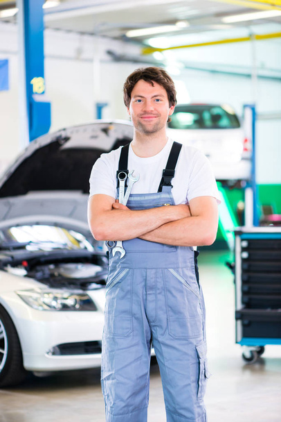 Mechanic working in car workshop - Photo, Image