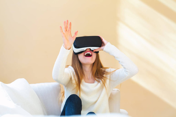 Young woman using virtual reality headset - Fotó, kép