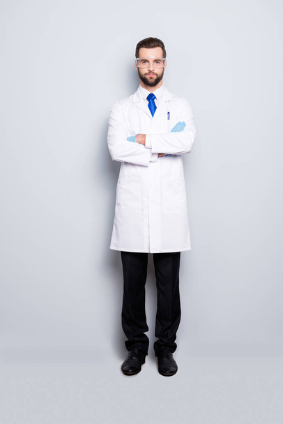 Full size fullbody portrait of stylish handsome scientist with stubble in white outfit with blue tie having his arms crossed looking at camera, isolated on grey background - Photo, image