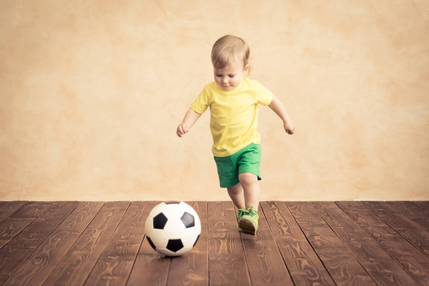 Child is pretending to be a soccer player. Success and winner concept - Zdjęcie, obraz