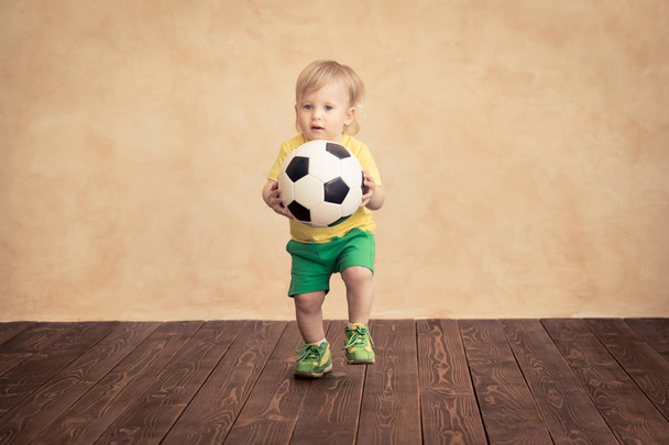 Child is pretending to be a soccer player. Success and winner concept - Foto, Imagem