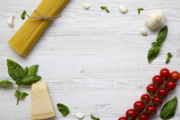 Frame with ingredients for cooking pasta on a white wooden table. Flat lay. From above. Copy space. Top view. - Photo, image