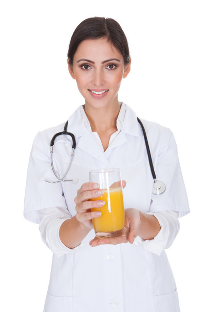 Happy Female Doctor Holding Orange Juice - Fotó, kép