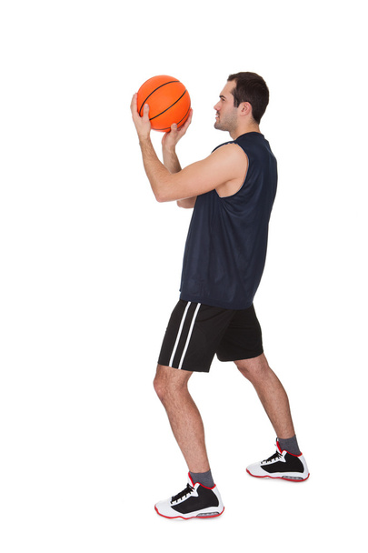 Professional basketball player throwing the ball - Фото, изображение