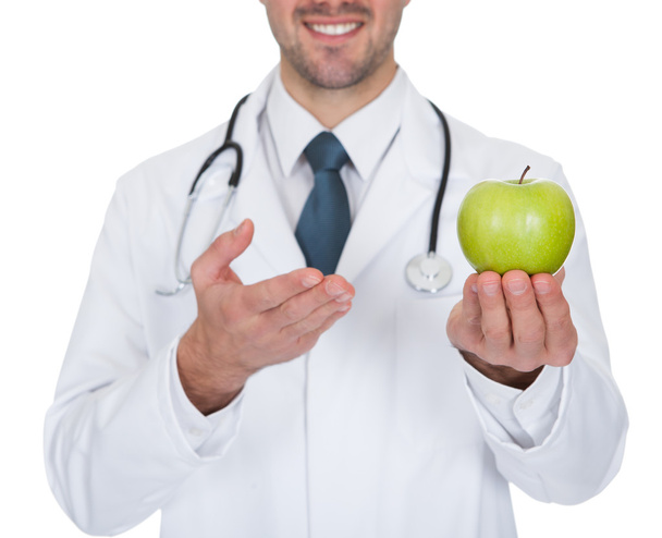 Médico masculino segurando maçã verde
 - Foto, Imagem