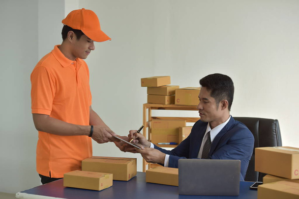 Delivery Business And online delivery services. Business Start up SME concept. Young startup entrepreneur small business owner working at home, packaging and delivery situation. - Photo, image