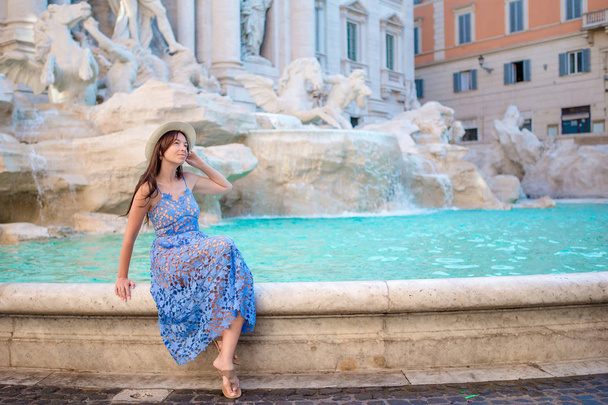 Young beautiful girl near fountain Fontana di Trevi with city map - Fotoğraf, Görsel