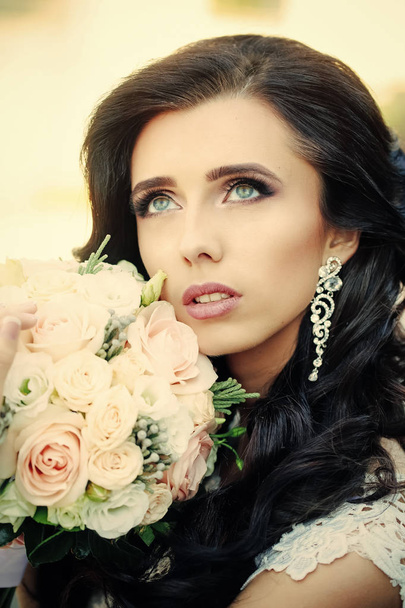 Bride with long brunette hair with flower. - 写真・画像