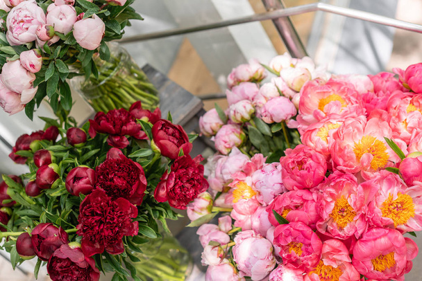 Floral shop. Beautiful bouquet of different varieties peonies. Wallpaper. Lovely flowers in vases - Zdjęcie, obraz