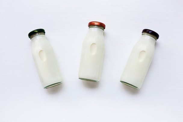 milk bottle on white background. Top view - Φωτογραφία, εικόνα