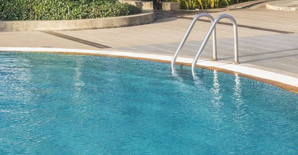 Grab bars ladder in blue swimming pool - Foto, immagini