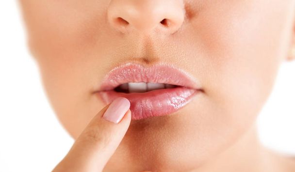 herpes on the lips, part of a woman's face with finger on lips with herpes, beauty concept - Foto, Imagem