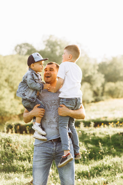 happy young father and two sons outdoors - Foto, Imagem