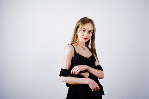 Girl model in black wear posed at studio on white background.  - Фото, изображение