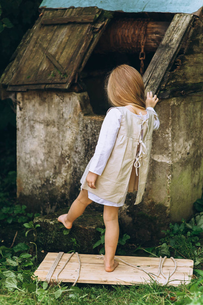 cute little girl with blond hair outdoors - Photo, Image