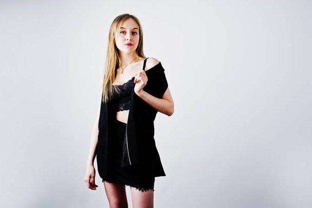 Girl model in black wear posed at studio on white background.  - Фото, изображение