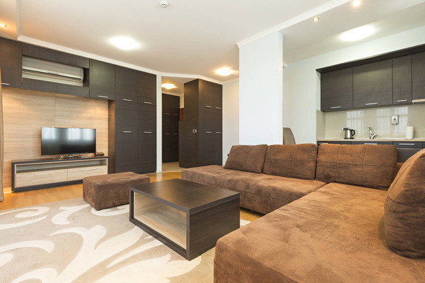 Interior of a modern open plan hotel apartment, living room - Fotó, kép