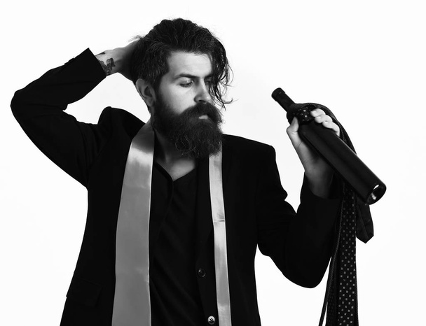 Brutal caucasian hipster with ties on shoulder holding bottle - Φωτογραφία, εικόνα