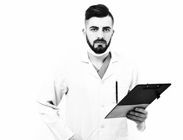 Doctor with beard holds clip folder for prescription - Foto, Imagem