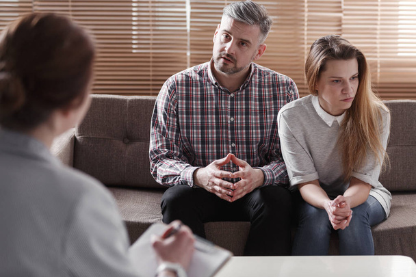 Depressed woman and husband talking with therapist for couples - Photo, image