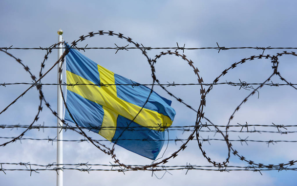 Swedish Border with Flag of Sweden and barbed Wire - Foto, afbeelding