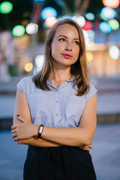 Portrait of a White Caucasian woman posing in city. She is dressed professionally in office attire and smiling  - Photo, image