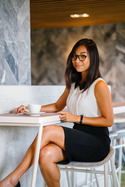 Business portrait for a young, attractive, athletic and cute Chinese Asian woman with coffee posing  in cafe - Φωτογραφία, εικόνα