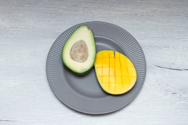 mango and avocado in plate on table - Fotó, kép