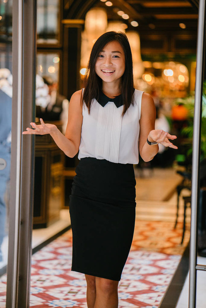 Professional portrait of a young, attractive, fit and cute Chinese Asian woman in an office or coworking space. She is smiling confidently - Zdjęcie, obraz