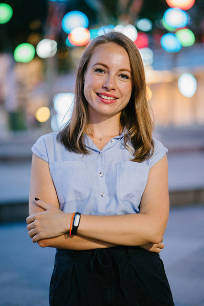 Portrait of a White Caucasian woman posing in city. She is dressed professionally in office attire and smiling  - Foto, Imagem