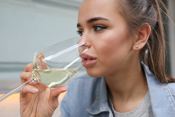 Portrait of a beautiful girl with a glass of white wine. - Φωτογραφία, εικόνα