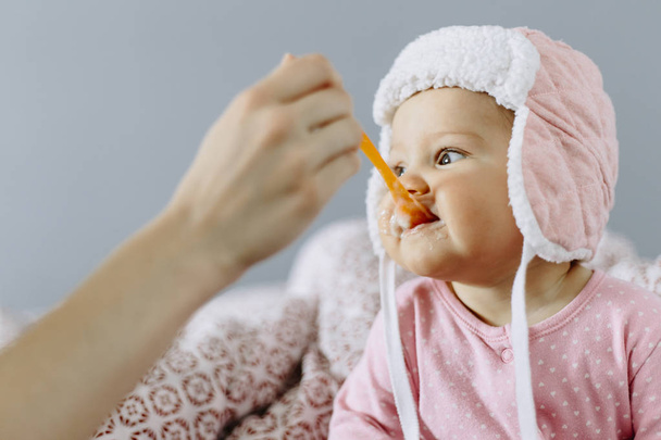 baby girl eating food from a spoon - Foto, Imagem